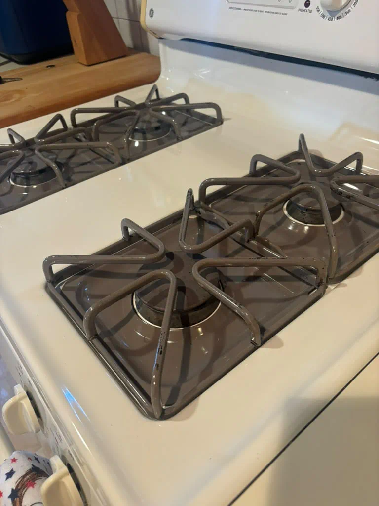 Clean stove with degreased grates and burners after deep cleaning in Gloucester